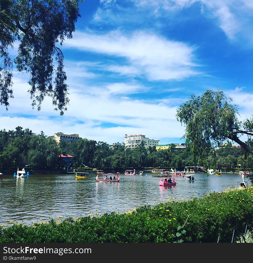 People Riding in Boat on Lagoon