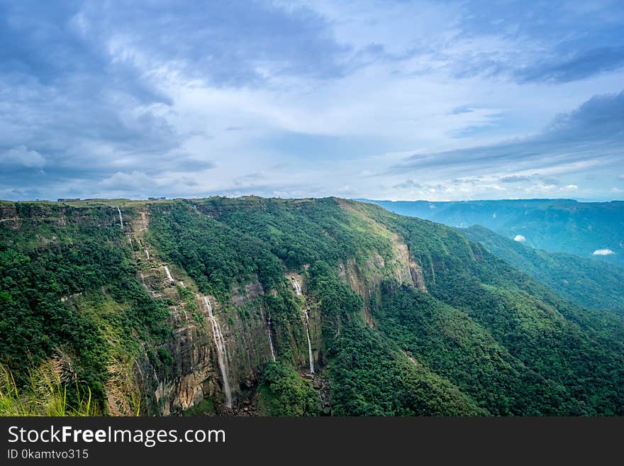 Brown Rock Cliff and Green Trees