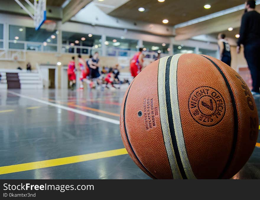 Brown Basketball on Grey Floor