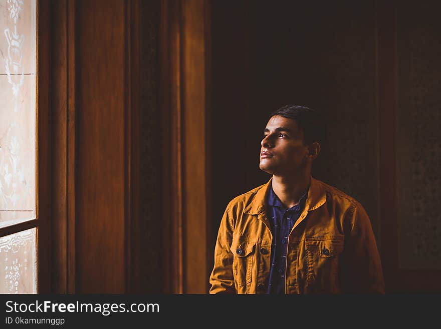 Photo of Man Looking Towards Window