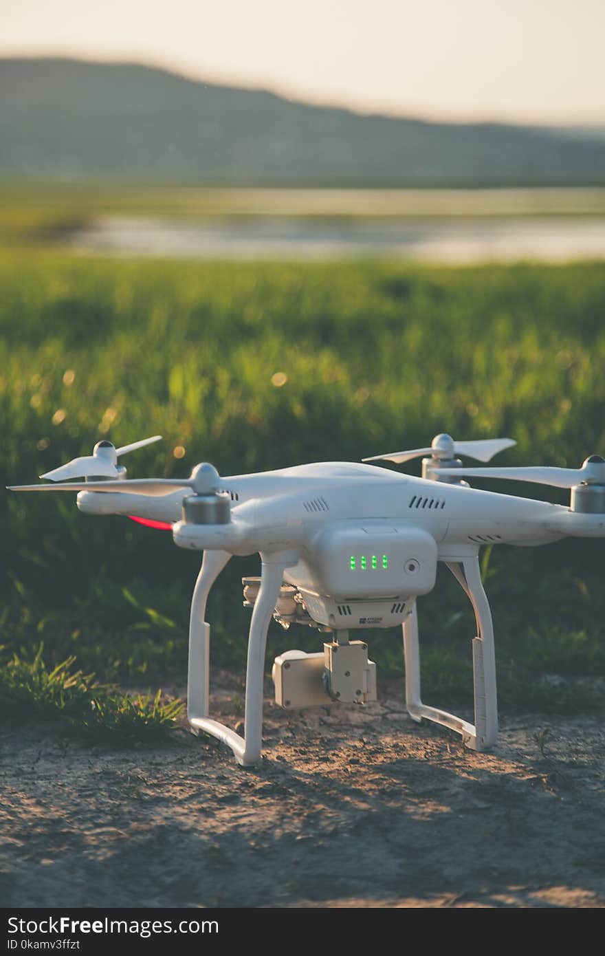 White and Gray Quadcopter on Ground