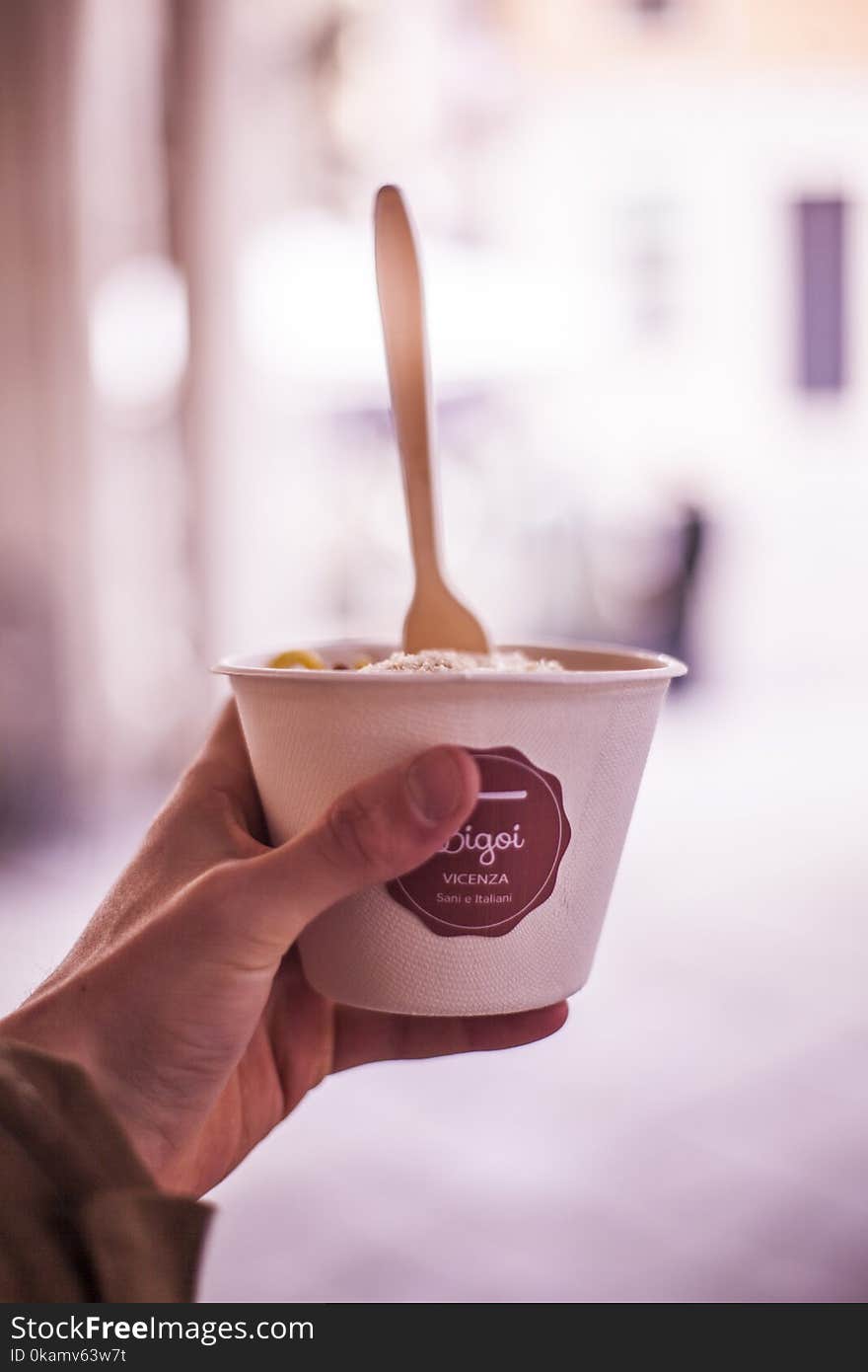 Selective Focus Photography of Person Holding Vacenza Labeled Cup