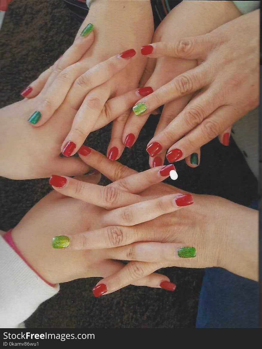 Women Holding Hear Hands Showing Their Nail Polishes