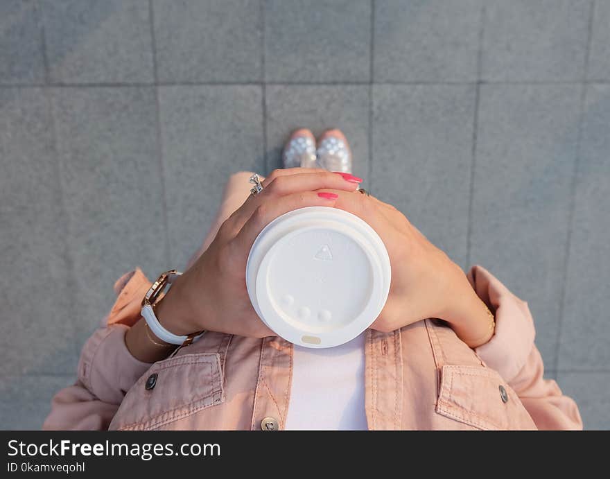 Person Holding White Disposable Cup