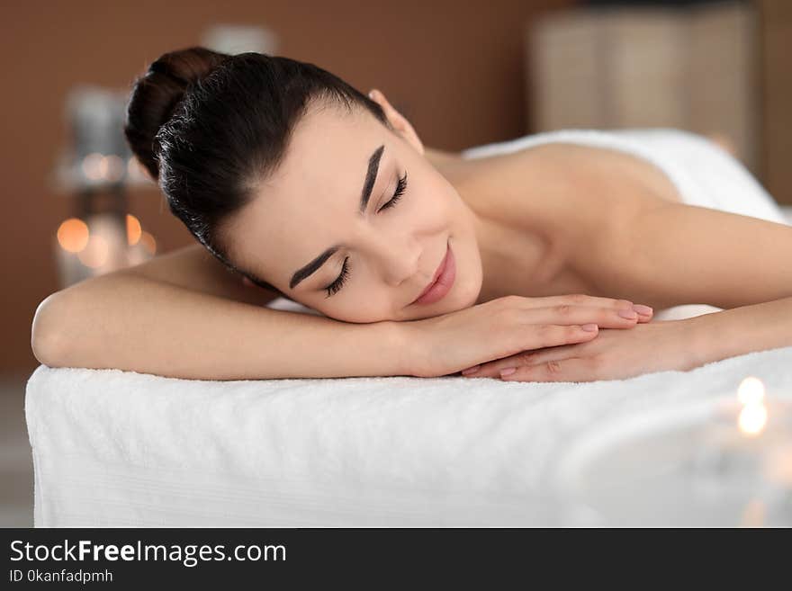 Young woman lying on massage table