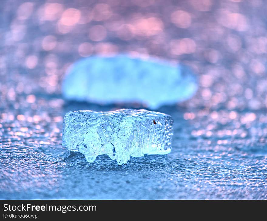 Ice shard and small cracked ice pieces on melring glacier. Icy fragments are melting