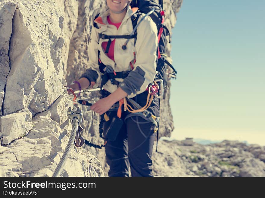 Closeup of female climber attaching via ferrata set.