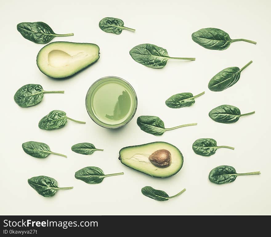 Concept of healthy eating, spinach leaves, avocado, smoothies on white background, flat lay