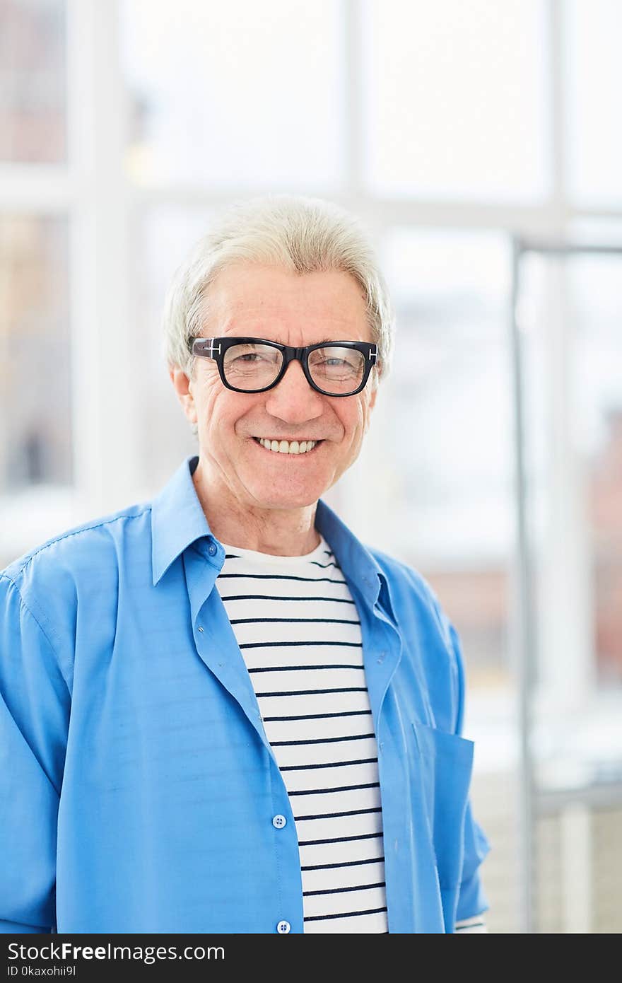 Portrait of senior businessman in eyeglasses smiling at camera. Portrait of senior businessman in eyeglasses smiling at camera