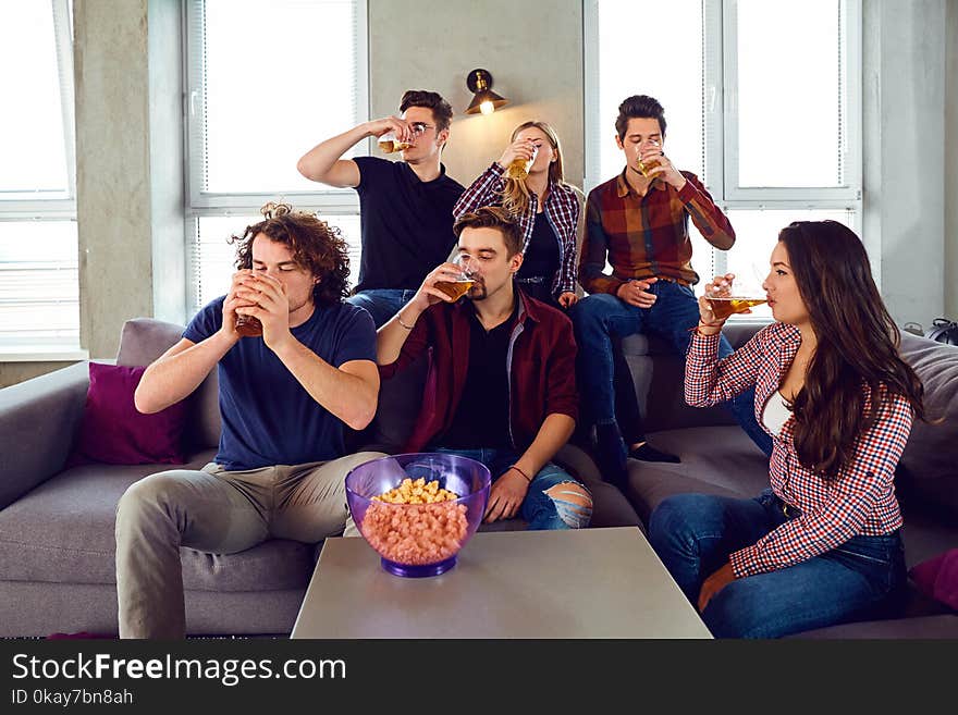 A Group Of Young People Are Drinking Beer.