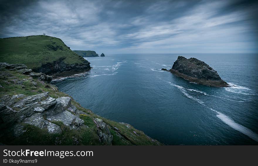 British calm coastline and a single building on a cliff. British calm coastline and a single building on a cliff.