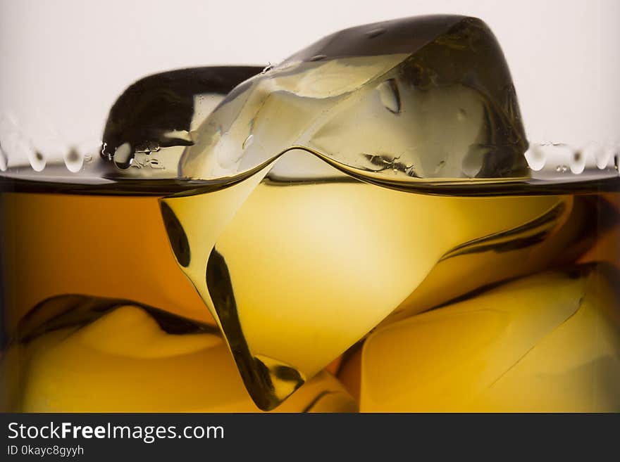 Slices Of Ice In A Glass With Whiskey Closeup