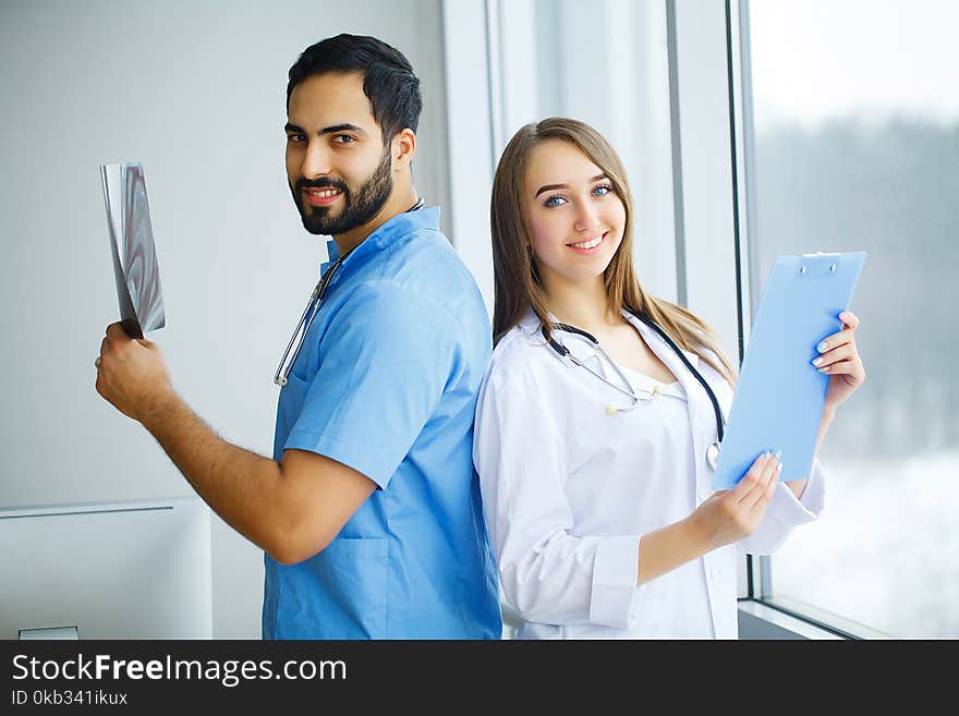 Male and female doctors work together in hospital.