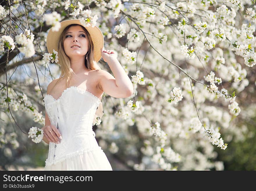 Young woman in the garden blooming in spring