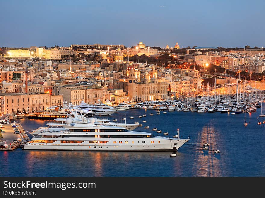 Valletta, Malta. Grand harbour, luxury yachts marina view from Upper Barrakka Gardens in the evening. Valletta, Malta. Grand harbour, luxury yachts marina view from Upper Barrakka Gardens in the evening