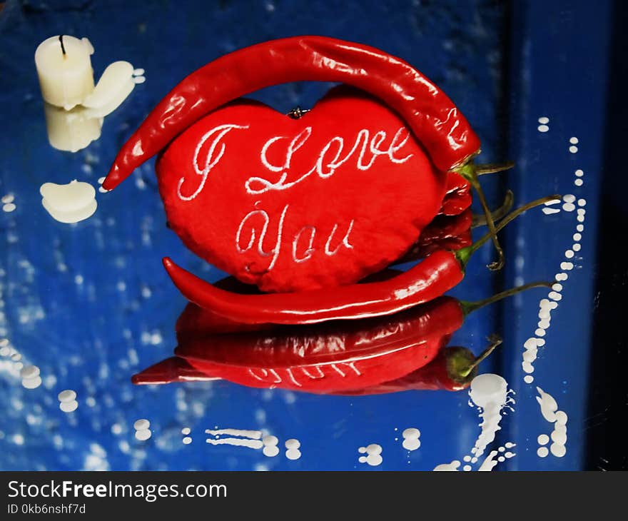 Two hearts on a dark background and a burning pepper