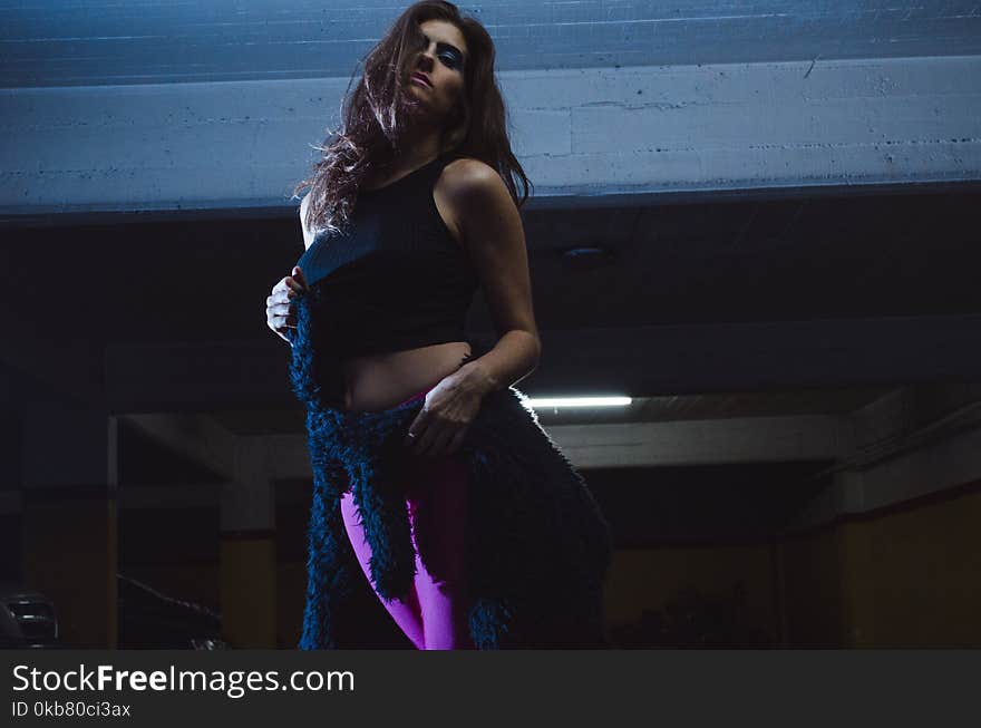 Photo of Woman Wearing Black Crop Top and Purple Leggings