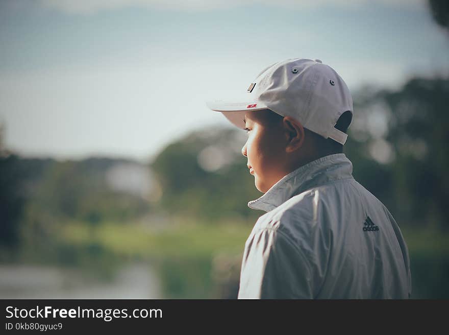 Kid Wearing White Cap and Adidas Jacket