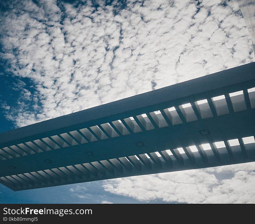 Silhouette of Bridge Under Cloudy Sky