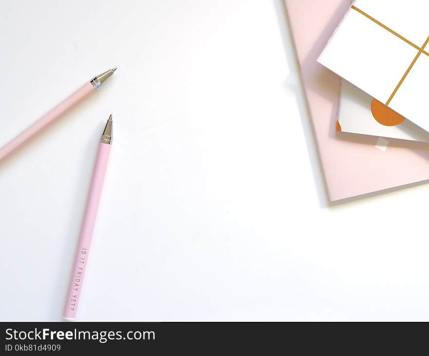 Two Pink Ballpoint Pens on Table