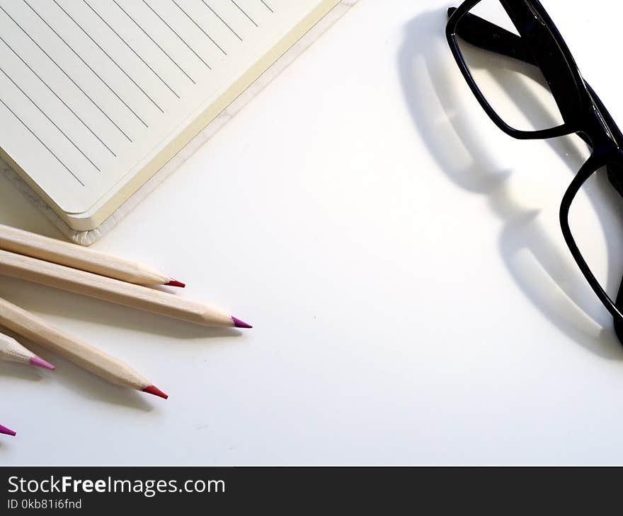 Black Framed Eyeglasses on Desk