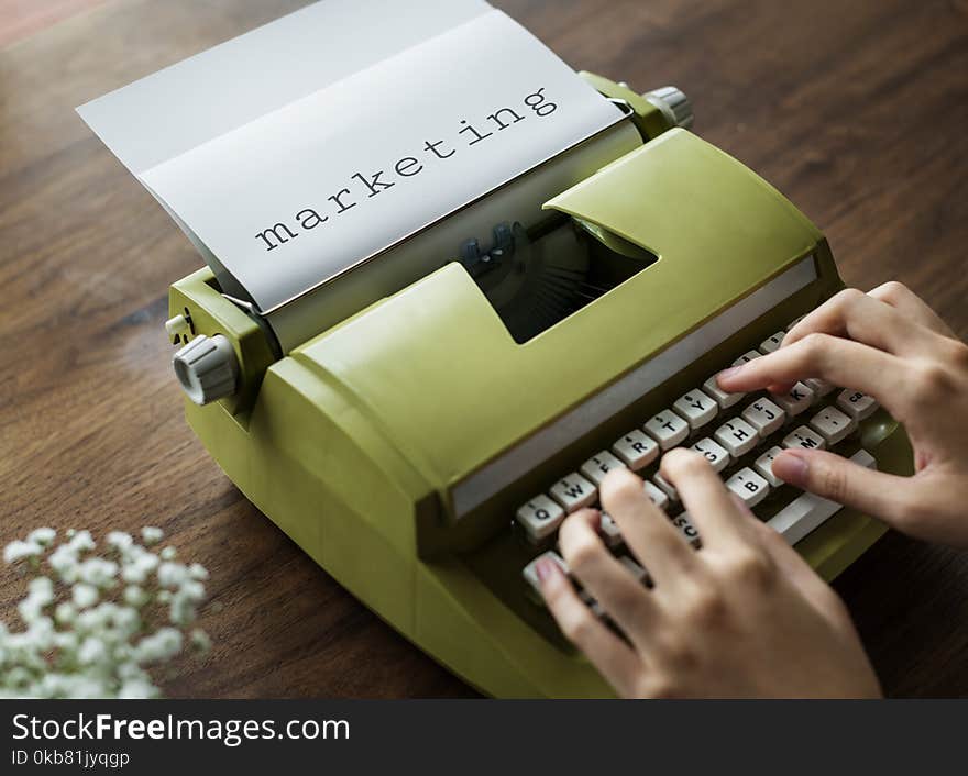 Person Typing on Green Typewrite