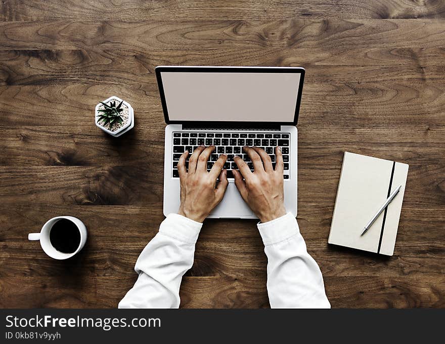 Human Using Black and Silver Laptop Computer