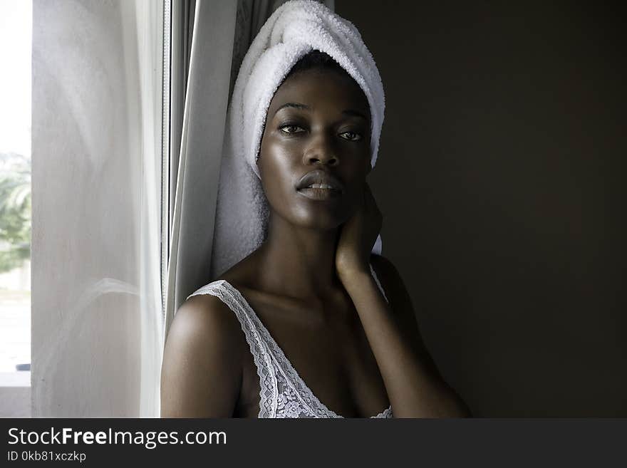 Closeup Photo of Woman Wearing White Top Looking on Camera