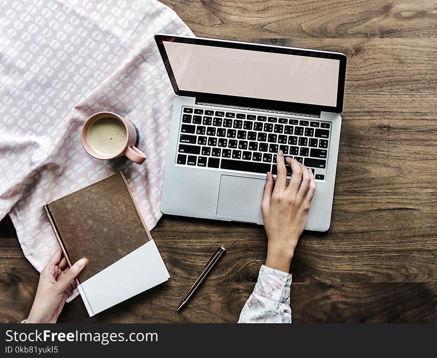 Person Touching Keyboard of Laptop