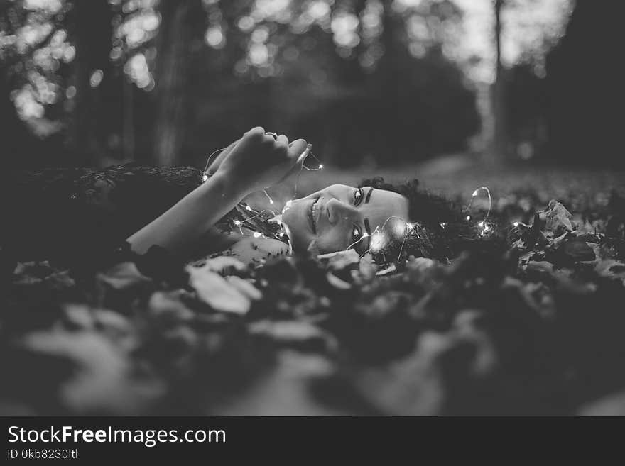 Grayscale Photo of Person Lying on Ground