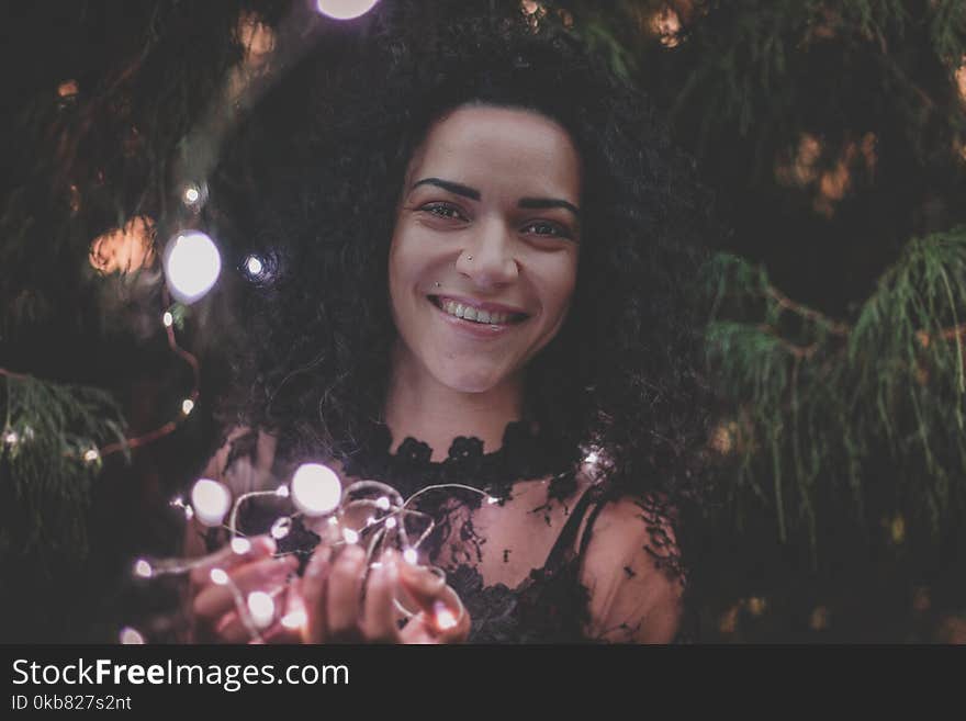 Close-U Photography of a Woman Holding String Lights