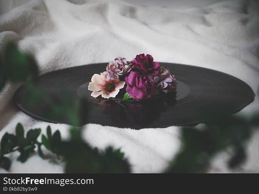 Selective Focus Photography of Flowers On Top of Vinyl Record