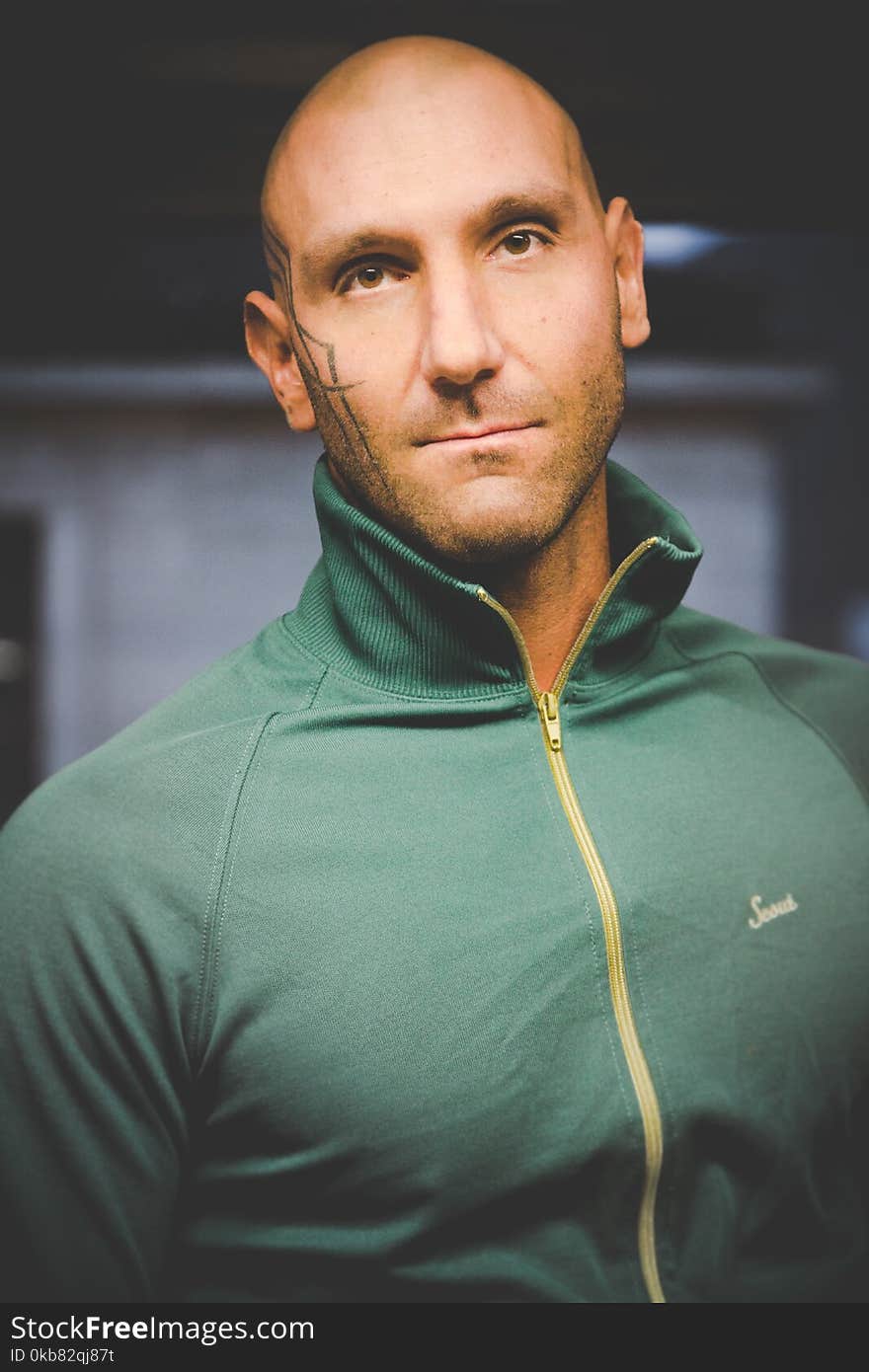 Man Wearing Green Zip-up Top