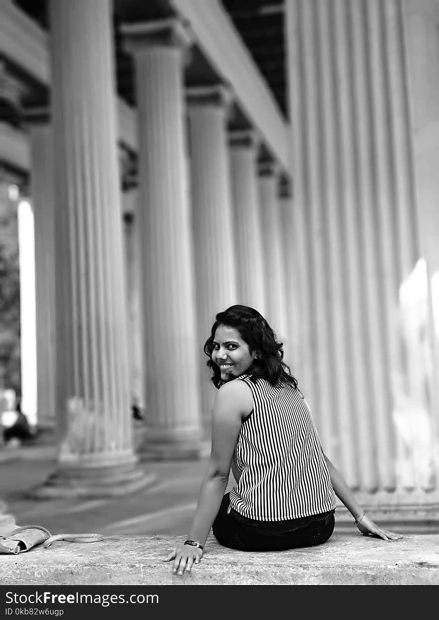 Woman Siting on Concrete Pavement Grayscale Photography