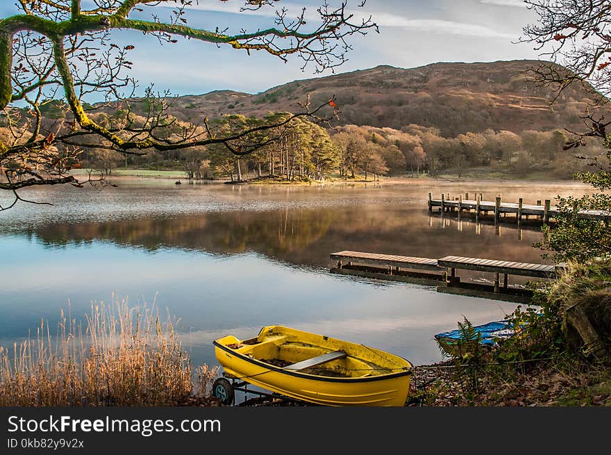 Landscape Photography of Yellow Punt Boat on Shoreline