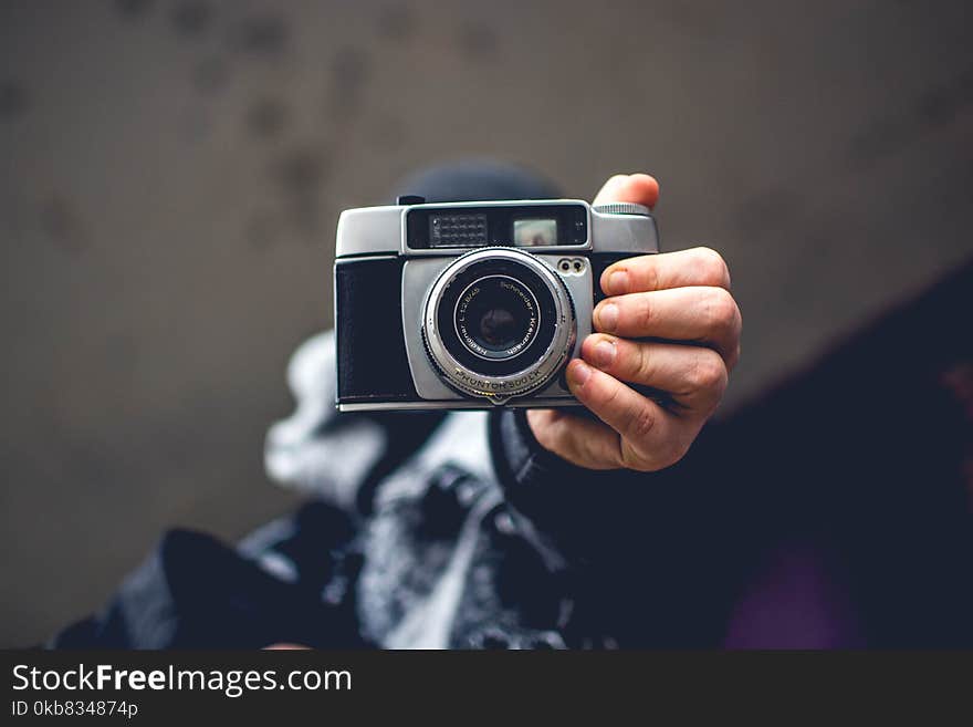 Person Holding Gray and Black Slr Camera