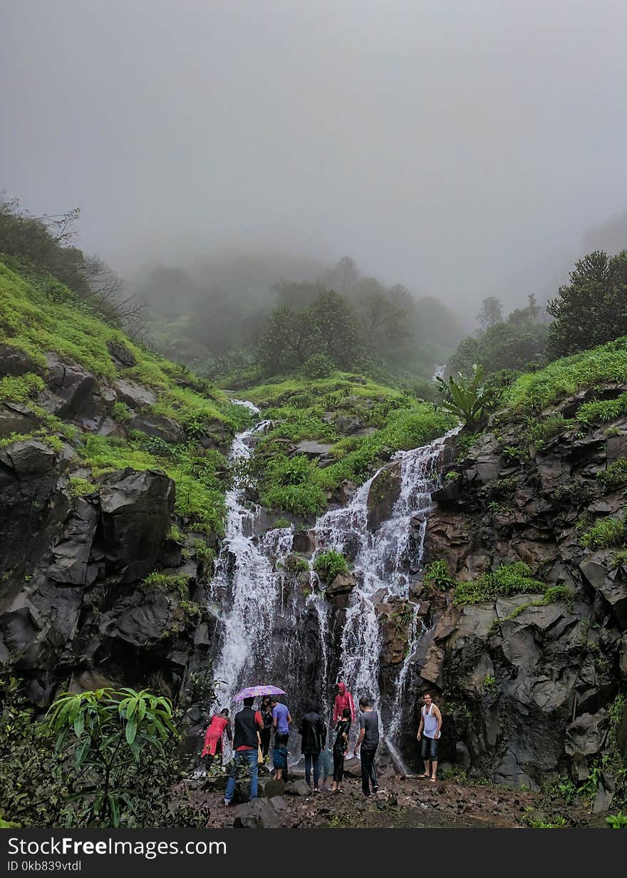 People In Front Of Waterfalls