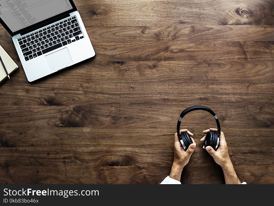 Photography of Person Holding Headphone