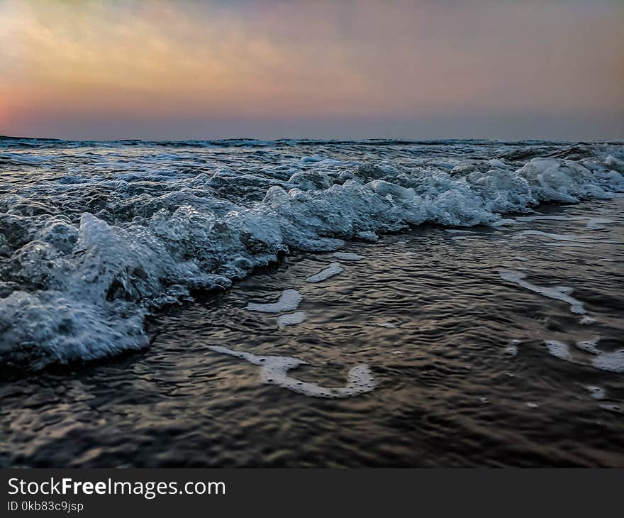 Body Of Water During Sunset