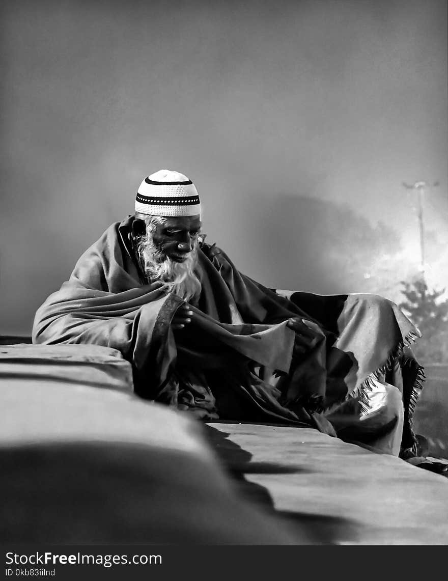 Grayscale Photo of Man With Taqiyah Cap