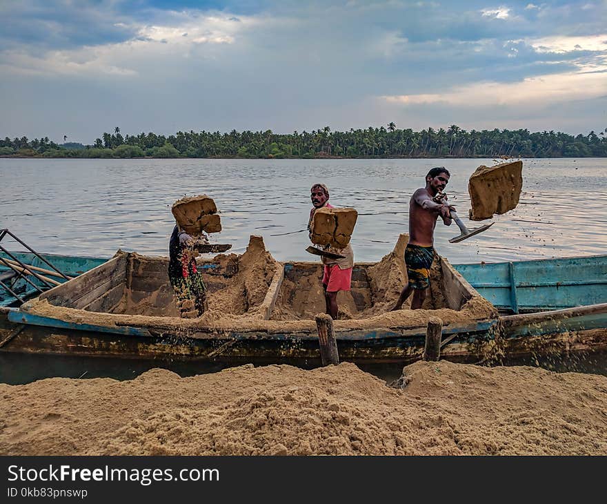 Three Person Standing On Blue Boat