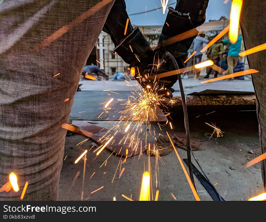 Man Cutting Steel Using A Power Tool