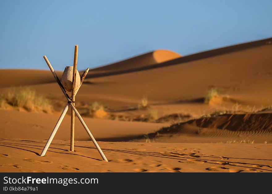 Brown Stone on Tripod Sticks at a Desert