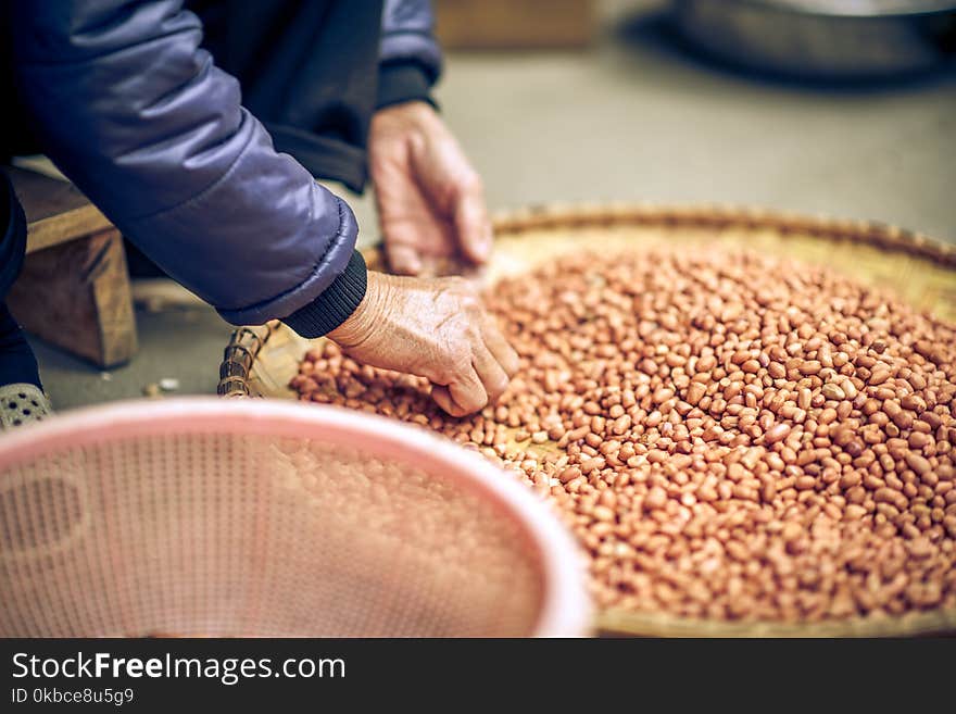 A woman cleaning peanuts in Vietnam