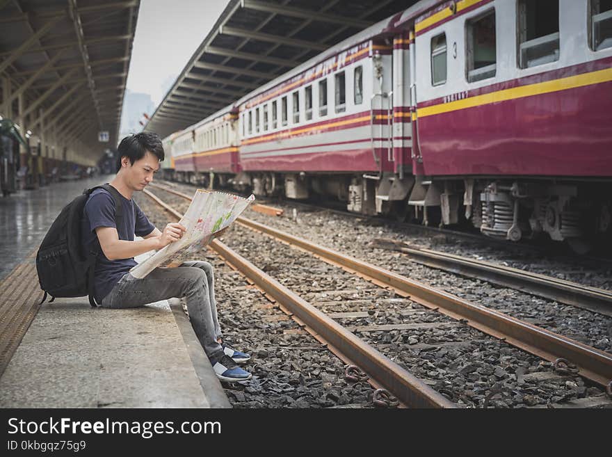 Tourist searching route on map at train station, travel concept. Tourist searching route on map at train station, travel concept