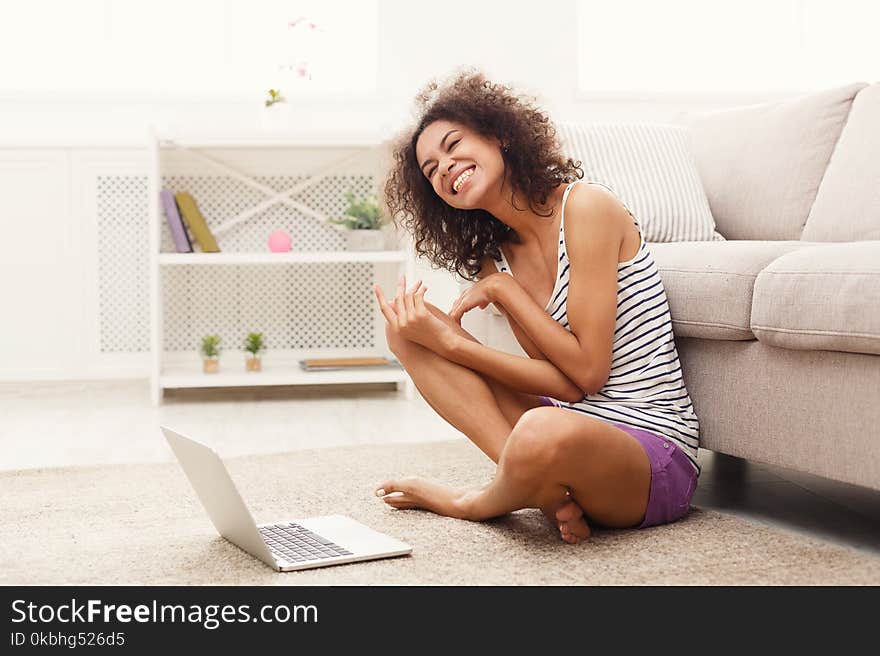 Excited Girl With Laptop Sitting On Floor