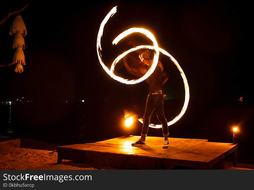 Light painting and long exposure picture of a street artist fire juggling performance. Phi Phi Island, Thailand. Light painting and long exposure picture of a street artist fire juggling performance. Phi Phi Island, Thailand.