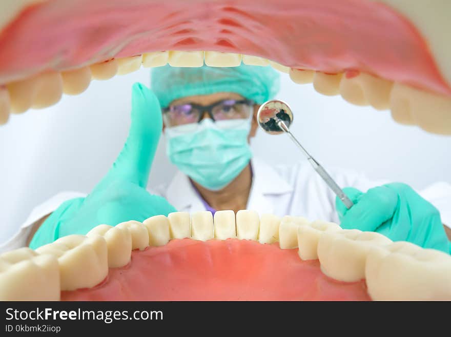 Dentist examine oral cavity with dental tool