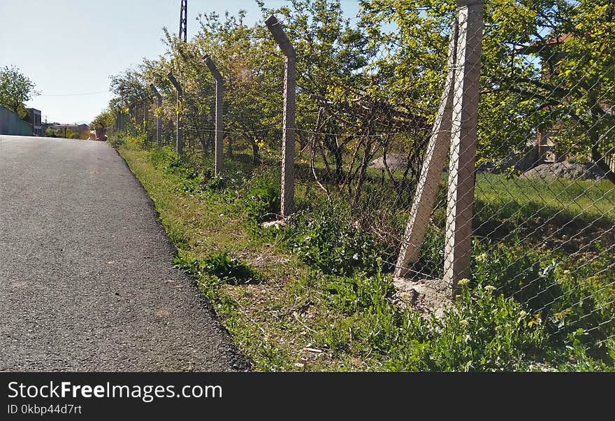 Gray Concrete Pavement Near Gray Wire Fence