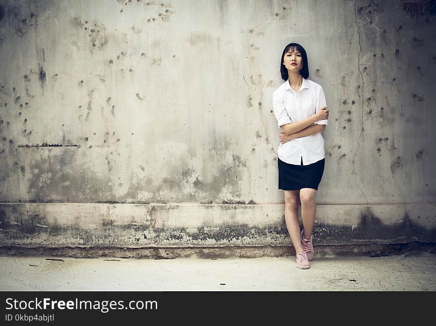 Woman Standing Next to a Wall